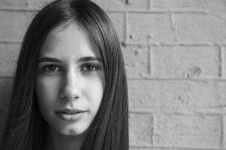 A very beautiful and cheerful girl stands on the street with long, luxurious hairの写真素材