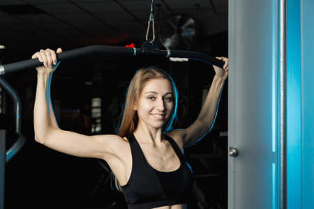 Thrust for the head, block simulator. Woman sit and warm-up. Studio shot.
