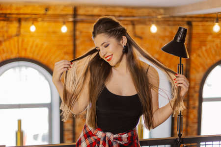 Beautiful and sexy girl posing in a cafe. Loft style.の写真素材
