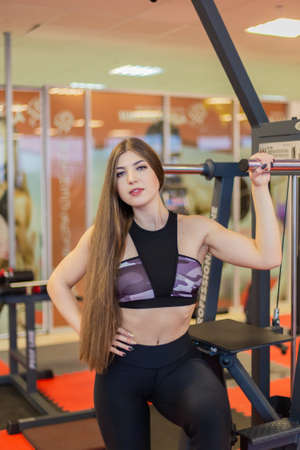 Beautiful athletic girl posing in the gym.
