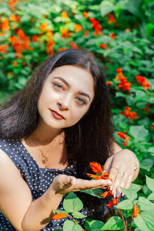 Plus size fashion model in casual clothes, overweight female body in a park outdoors.