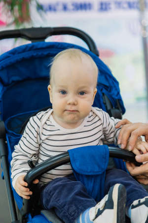 Little baby in a stroller in the mall.