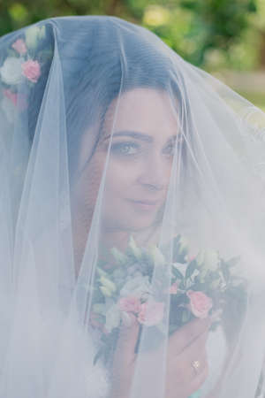 Very beautiful bride is holding a bouquet.の写真素材