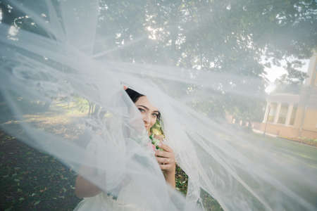 Very beautiful bride is holding a bouquet.の写真素材