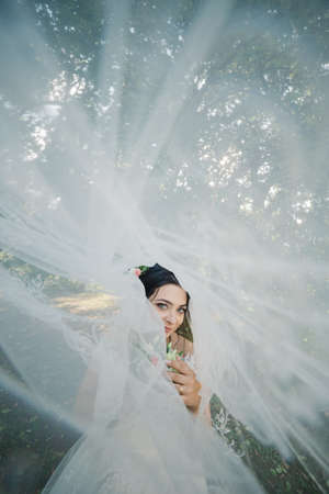 Very beautiful bride is holding a bouquet.の写真素材