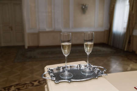 Two glasses of champagne on a tray.の写真素材