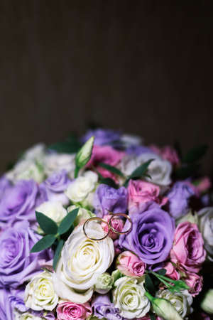 Wedding bouquet and rings illuminated by photo with light.の写真素材