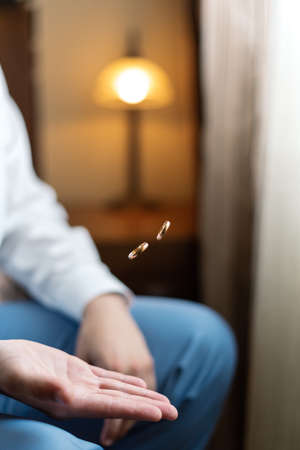 two wedding rings on the palm of the groom.の写真素材