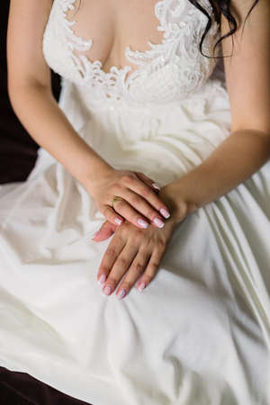 Beautiful hands of a young bride in a wedding dress.の写真素材