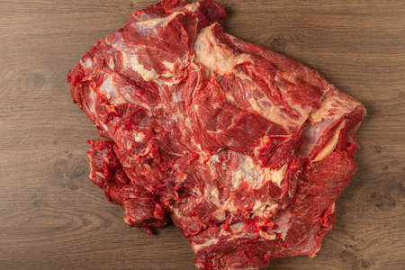 Raw fresh beef on a wooden background, catalog.