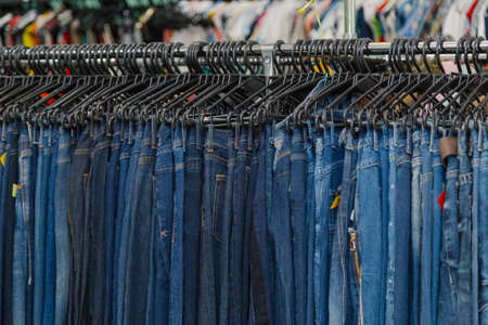 Colorful clothes on hangers in a store.の写真素材