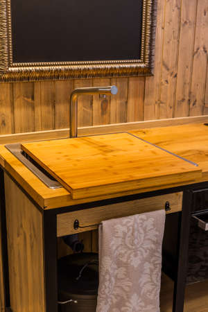 Modern sink in a wooden kitchen in the interior.の写真素材