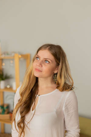 Beautiful woman portrait at home in modern interior.