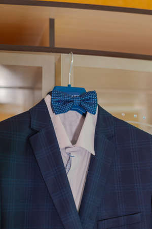 Stylish mens jacket hanging on a hanger.の写真素材