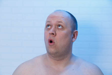 Portrait of a bald man who is surprised.の写真素材