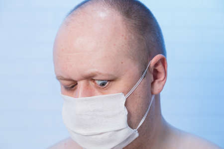 Portrait of a bald man who is in a medical mask.の写真素材