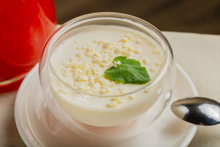 Fresh dessert with white chocolate in a transparent bowl.