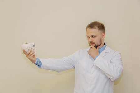 Male doctor with a skull in his hands.