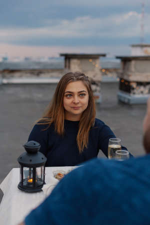 Lovers on the roof sit at a table with champagne.の写真素材