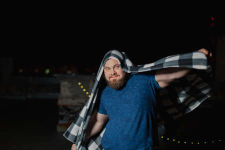 Big bearded man covered with a blanket.の写真素材