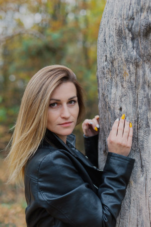 Beautiful woman portrait in forest in autumn.