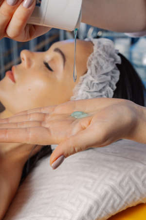 Professional beautician woman pours wash gel on hand.の写真素材