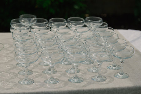 Empty cocktail glasses on a table with a white tablecloth. close-up