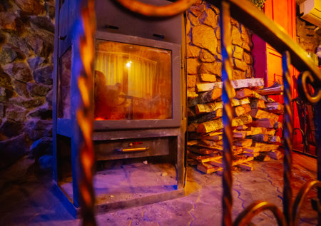 Beautiful antique fireplace with wood for kindling. Warm interior environmentの写真素材