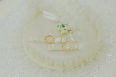 New wedding gold rings lie on a handmade white pillow happy wedding day. wedding ceremony. view from...