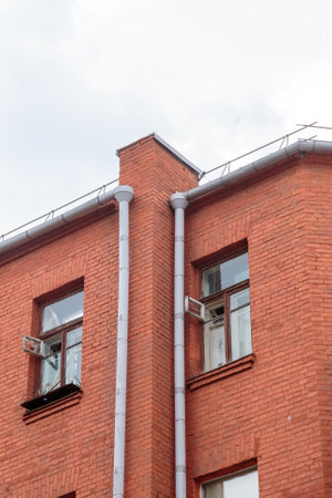 The facade of the old red brick building that was built 100 years ago against the backdrop of the...
