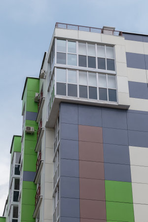 The facade of a modern building in which people live in apartments in the city center. modern new...