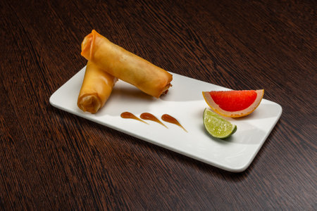Stuffed pancakes on a white plate with lime and grapefruit