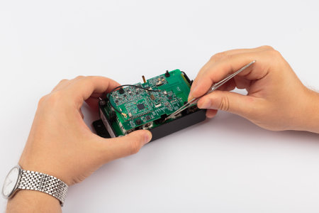 Hands holding an electronic board on a white background