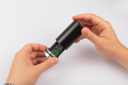 Hands holding an electronic board on a white background