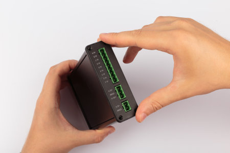 Hands holding an electronic board on a white background