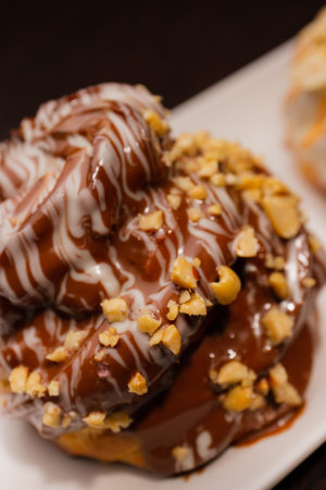 Cinnamon roll on a white plate and on a wooden table