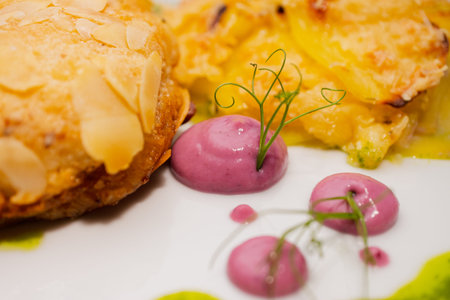 Chicken cutlets sprinkled with almonds on a white plate