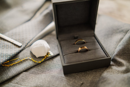 Wedding rings in a box with mens wedding accessories