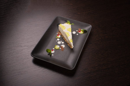 A slice of cottage cheese pie on a plate with beautiful decoration