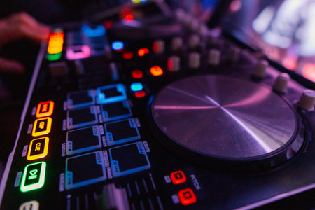 A DJ booth in the evening lights of a club