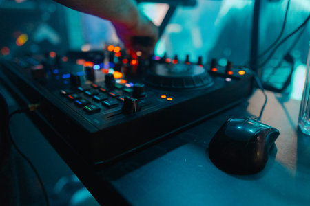 A DJ booth in the evening lights of a club
