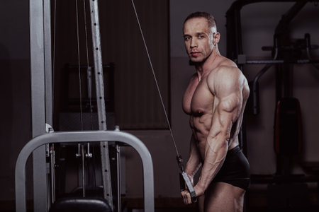 Bodybuilder training in the gym, aesthetic body