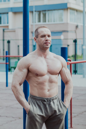 A CrossFit man poses for the camera on a sports ground