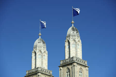 Grossmunster cathedral with flagged steeples, Zurich, Switzerlandの写真素材