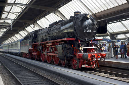 Zurich, Switzerland - June 4, 2011: A train with a refurbished Pacific 01 202 steam locomotive is ready to depart from Zurich main station (Hauptbahnhof).のeditorial素材