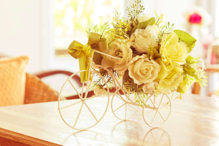 White roses in a bicycle vase on vintage.の写真素材