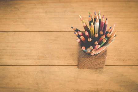 group of color pencils in a wood cup ,retro vintage style top view.の写真素材