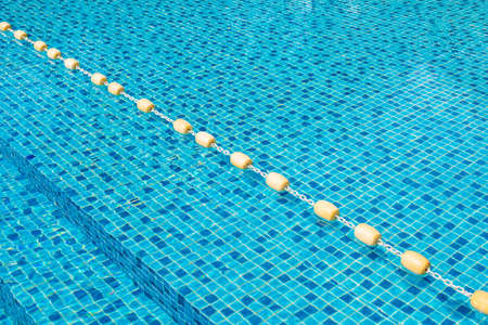 Plastic buoy are floating in the swimming pool