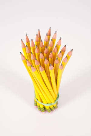 A bouquet / bunch of yellow, #2 pencils set against a white background.の写真素材