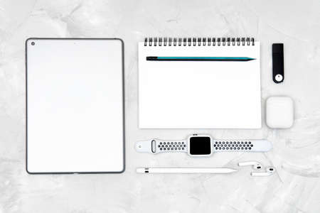 Flat lay of traditional and modern tools of any designer: paper notebook, pencil, smartwatch,...